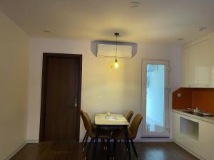 a kitchen with a table and chairs and a light at KP Home in Xuân Trach