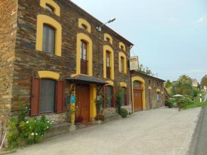 a brick building with yellow doors on a street at Casa Venancio in Trabada