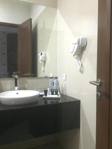 a bathroom with a sink and a mirror at Avilla Puncak in Puncak