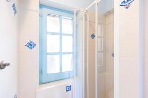 a shower with a blue window in a bathroom at Blue View - A Due Passi dal Mare & Natura in Quartu SantʼElena +32 photos