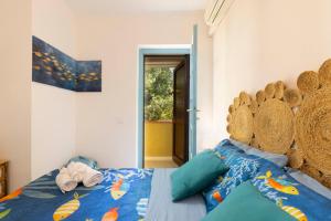 a bedroom with a bed with a large wooden headboard at Blue View - A Due Passi dal Mare & Natura in Quartu SantʼElena
