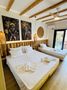 two beds in a room with two posters on the wall at Hotel marmaras in Neos Marmaras