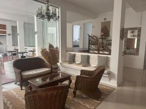 a living room with a couch and chairs and a table at Hotel Azul by MH in Punta del Este