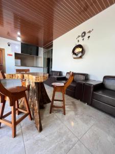 a living room with a table and chairs and a couch at Hotel Star Rio in Novo Airão