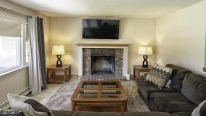 a living room with a couch and a fireplace at Centrally Located, Outdoor Dinning and Game Table in Barnstable