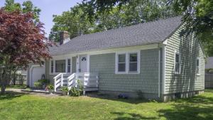 a small green house with a yard at Centrally Located, Outdoor Dinning and Game Table in Barnstable