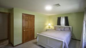 a bedroom with a bed with purple pillows at Centrally Located, Outdoor Dinning and Game Table in Barnstable