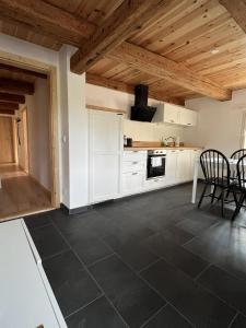 a kitchen with white cabinets and a table and chairs at Vierseithof "Waitzdorfer Hof" in Hohnstein +31 photos