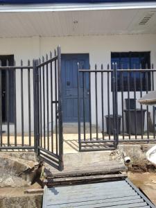a gate in front of a building with blue doors at PrincessStar in Pagadian
