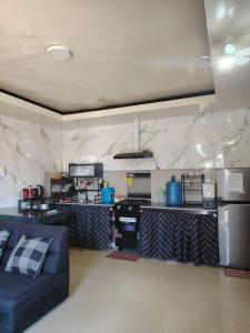a living room with a couch and a kitchen at PrincessStar in Pagadian