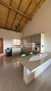 a kitchen with a table and chairs in a room at Pousada Recanto Namastê - Mandalah in Cunha