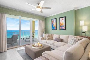 a living room with a couch and a table at Luxury Beachfront Condo Free Beach Chairs Huge Balcony Come Relax! in Panama City Beach