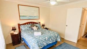 a bedroom with a bed and a picture on the wall at The Orchid Courthouse - Busselton in Geographe