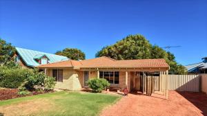 a house with a fence in a yard at The Orchid Courthouse - Busselton in Geographe