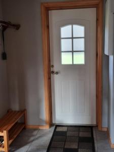 a white door with a window in a room at Cozy cabin close to nature in Sorreisa +8 photos