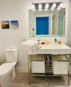 a bathroom with a sink and a toilet and a mirror at Lakeview Bed and Breakfast in Kelowna +12 photos