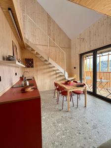 a kitchen with a table and chairs and a staircase at Winnica Przybysławice in Przybysławice