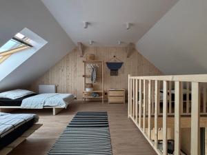 a attic bedroom with a bed and a crib at Winnica Przybysławice in Przybysławice