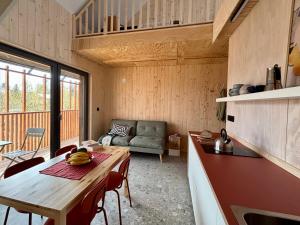 a kitchen and living room with a table and a couch at Winnica Przybysławice in Przybysławice +37 photos