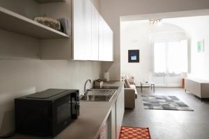 a kitchen with a sink and a stove top oven at Caudium B&B in Montesarchio