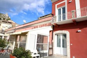 a red building with a cafe cafe sign on it at Caudium B&B in Montesarchio