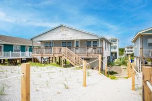 a house with a deck on the beach at Blue Haven by Oak Island Accommodations in Oak Island