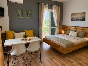 a bedroom with a bed and a table and chairs at Apartments Vista Mar in Orikum