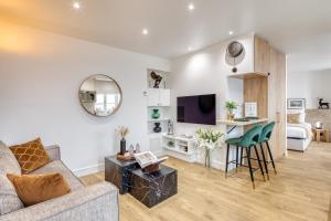 a living room with a couch and a tv at Paris Central Gem 9 Min Walk to Notre-Dame and Louvre in Paris +77 photos