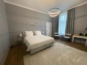 a bedroom with a white bed and a table and chairs at Villa Damseaux in Spa +108 photos