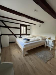 a bedroom with a large bed and a window at Vierseithof "Waitzdorfer Hof" in Hohnstein