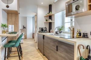 a kitchen with a sink and a counter top at Paris Central Gem 9 Min Walk to Notre-Dame and Louvre in Paris