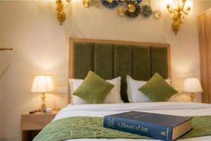 a book is sitting on top of a bed at Swaranjali in Chikhli