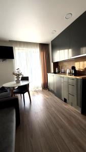 a kitchen with a table and a dining room at Kopa9 in Palanga