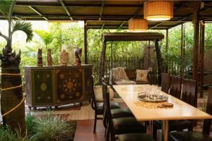 an outdoor dining room with a table and chairs at Swaranjali in Chikhli +15 photos