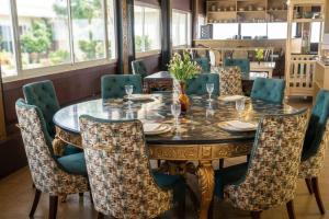 a dining room with a table and chairs at Swaranjali in Chikhli
