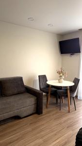 a living room with a couch and a table at Kopa9 in Palanga
