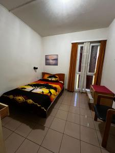 a bedroom with a bed and a table and a window at Giada in Iragna
