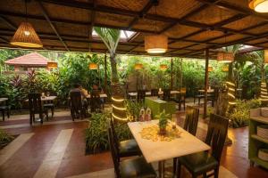 a restaurant with a table and chairs and plants at Swaranjali in Chikhli