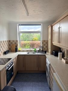 a kitchen with a sink and a window at Sycamore haven in Spinney Hill