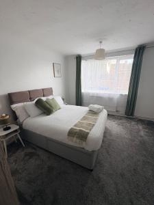a bedroom with a large bed and a window at Sycamore haven in Spinney Hill