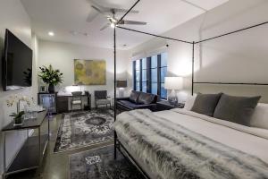 a bedroom with a large bed with a ceiling fan at The 121 Hotel in Nashville