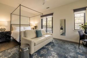 a bedroom with a bed and a couch and a desk at The 121 Hotel in Nashville +28 photos
