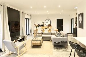 a living room with a couch and a table at Cape Winelands Mountain View Getaway in Dalsig