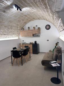 a living room with a table and a couch at Buonaventura house2 in Triggiano