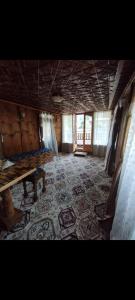 an empty room with a table and a rug at FREEDOM houseBoat in Srinagar