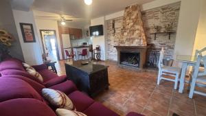 a living room with a couch and a fireplace at Casa La Cañada by CasaTuristica in Ronda
