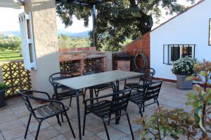 a table and chairs sitting on a patio at Casa La Cañada by CasaTuristica in Ronda
