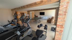 a living room with a gym with a treadmill at The Wimpey At Mill Cottage in Bedford