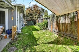 a backyard with a fence and green grass at Basecamp GP- Private Unit in Quiet Duplex Near Downtown in Grants Pass