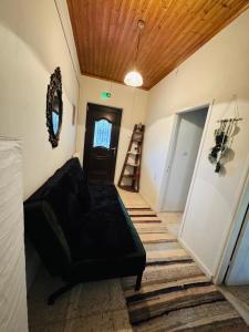 a living room with a couch and a wooden ceiling at Gaias Hideway in Áno Vlasía